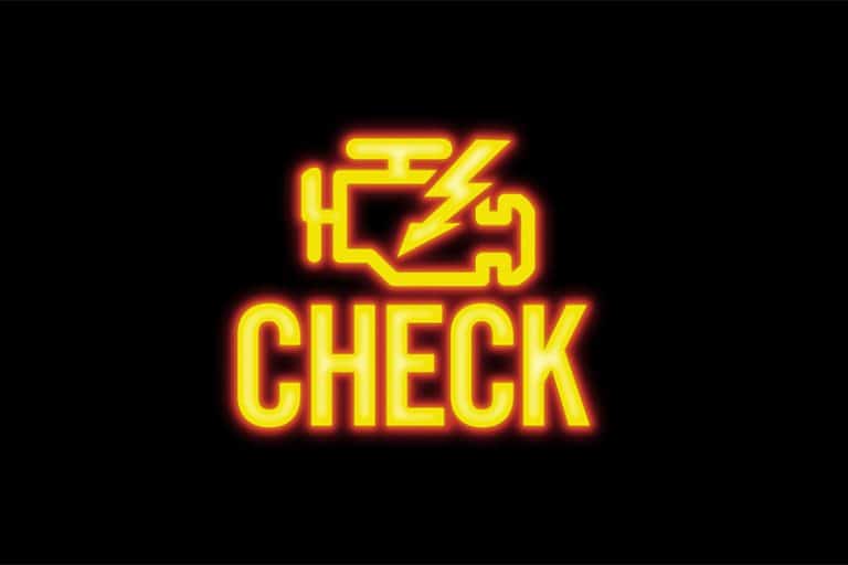 A car dashboard with the check engine light illuminated