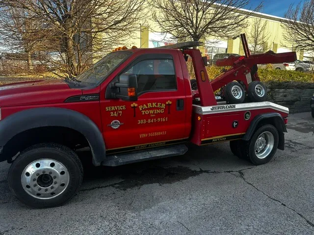 Parker Towing’s red 24/7 wrecker on a recovery call